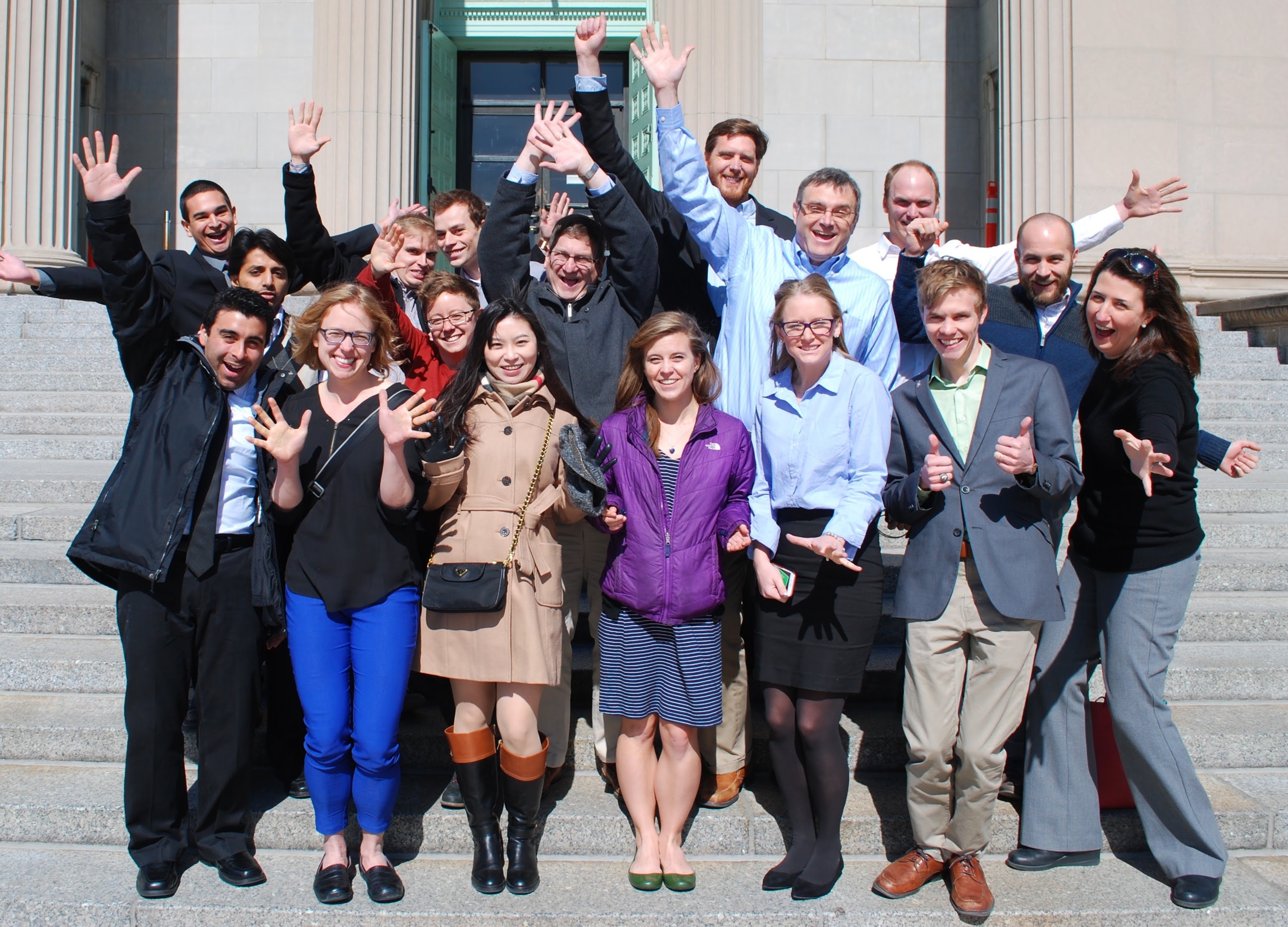 Group of students posing on building steps.