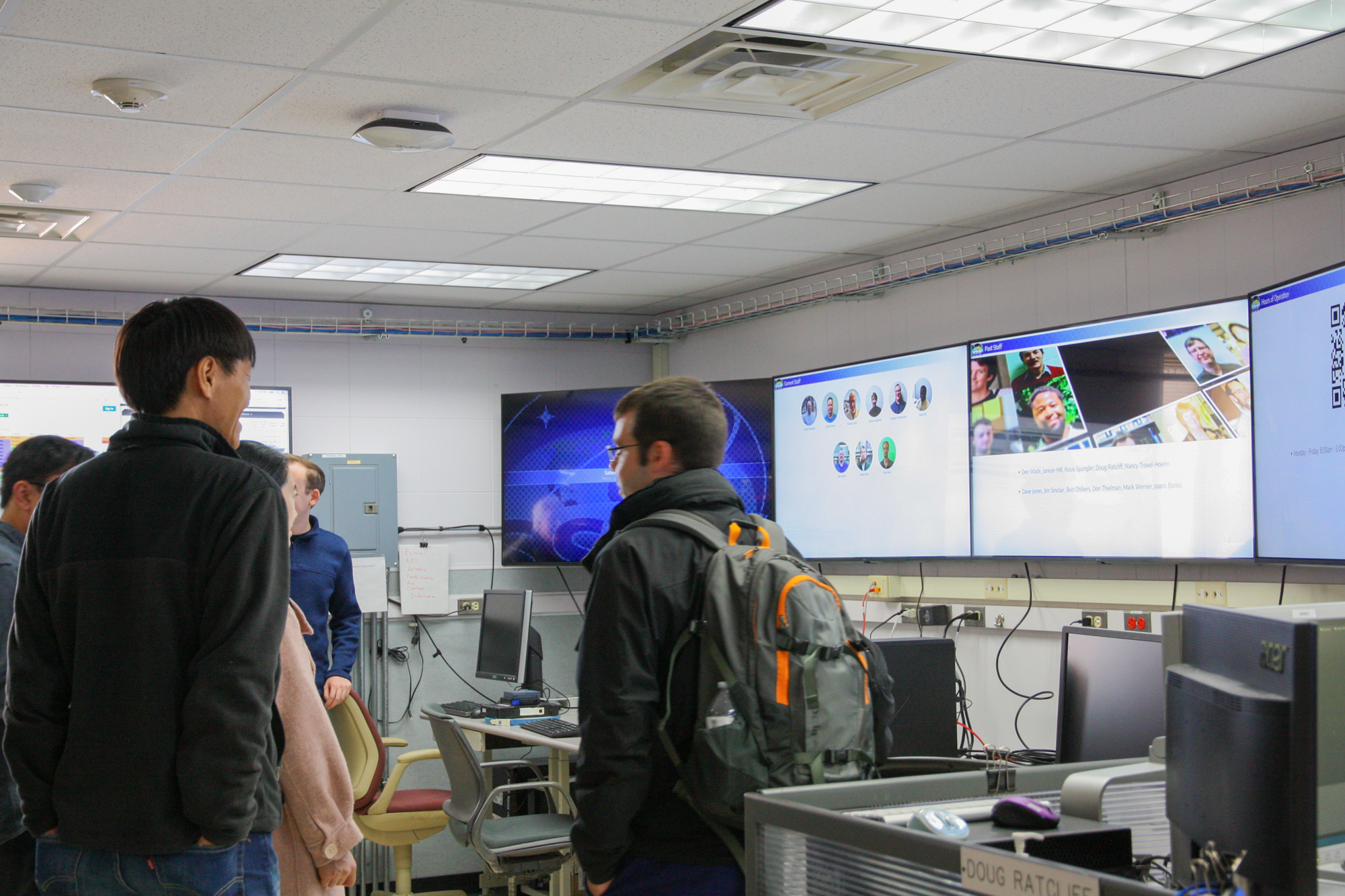 People standing in a computer lab.