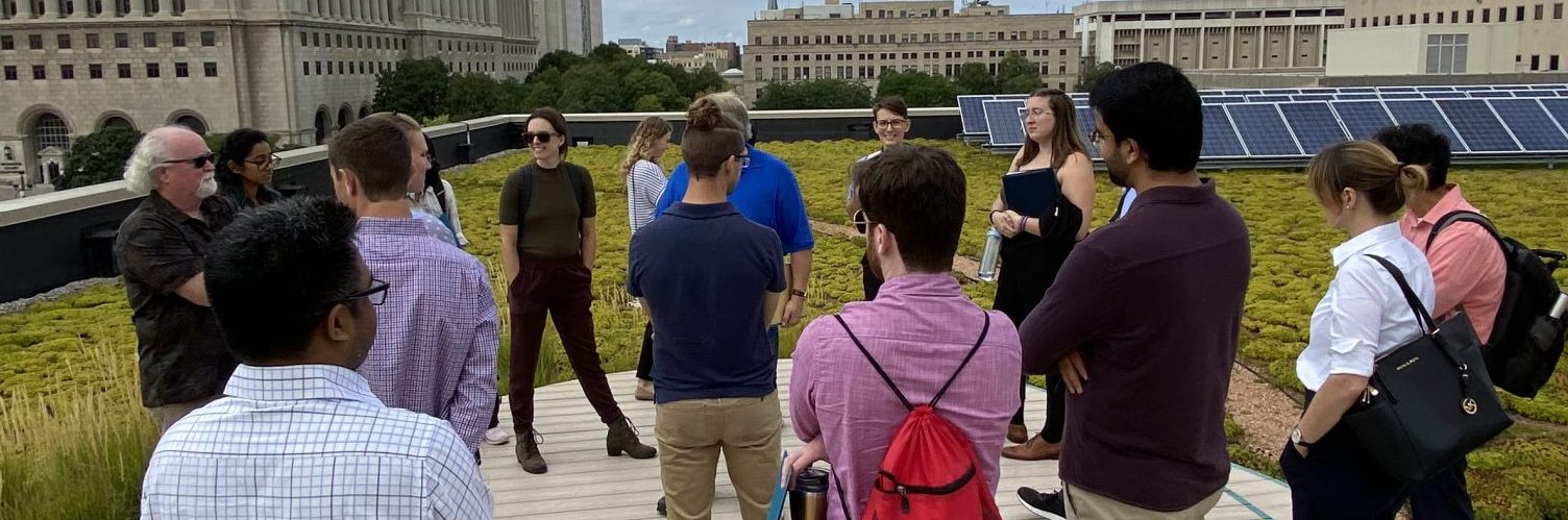EAP students vist a rooftop with a solar array.