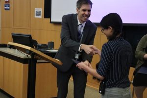 A man and a woman shake hands.